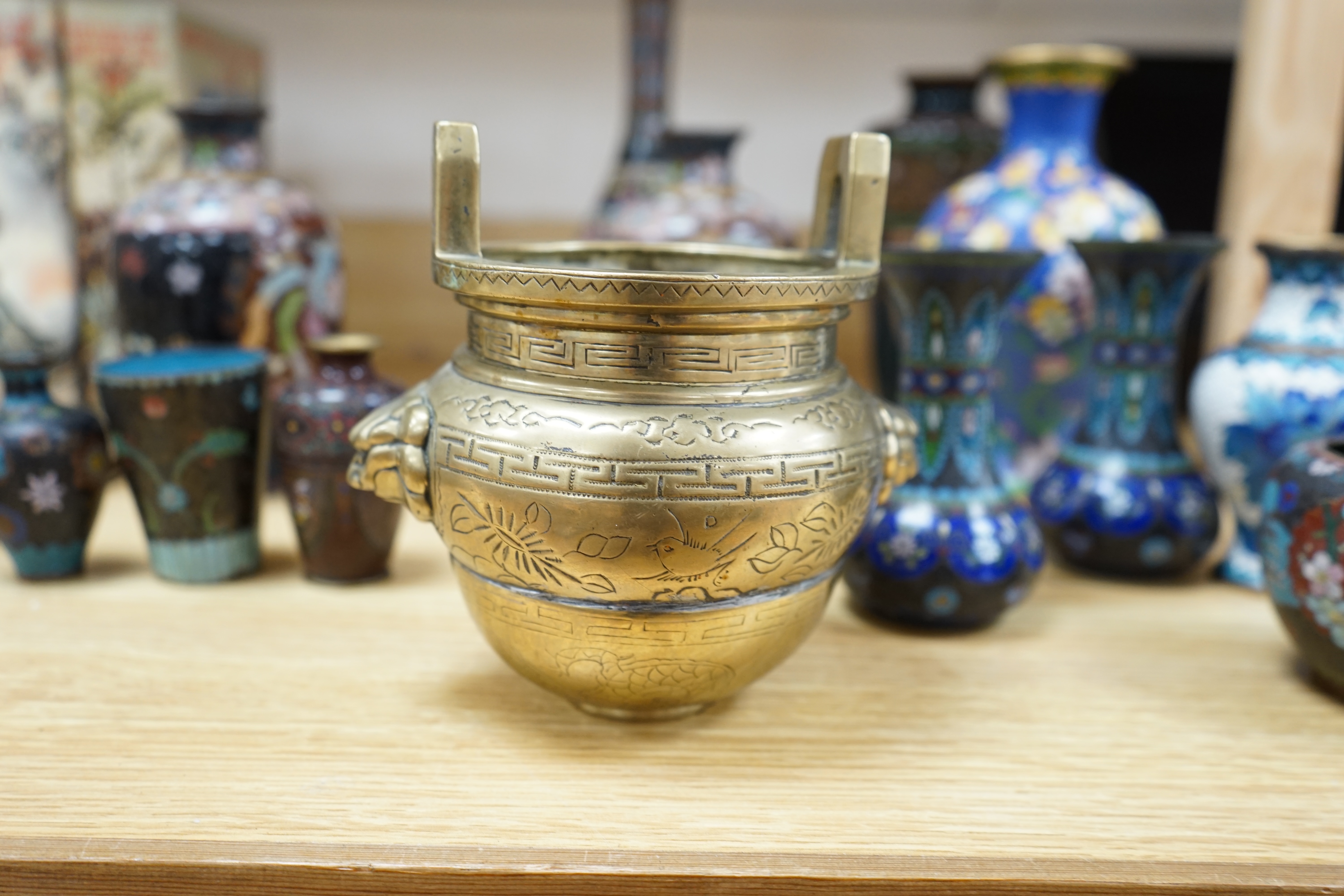 A large collection of Chinese and Japanese cloisonné vases and a brass twin handled censer, largest 31cm high. Condition - mostly poor to fair